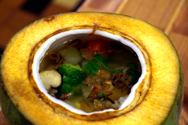 Sopa de verduras servida en un coco.